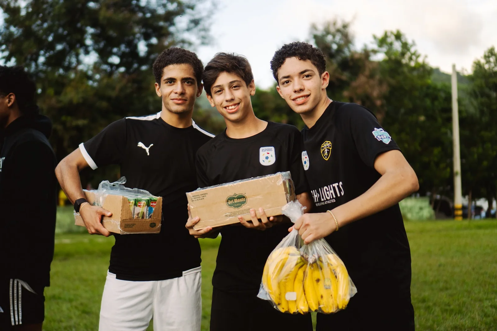 Highlights athletes carrying food for a community activity