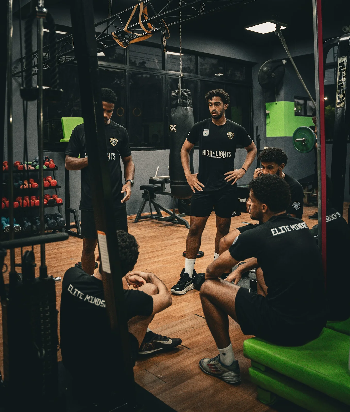 5AM Club athletes listening during a gym training session