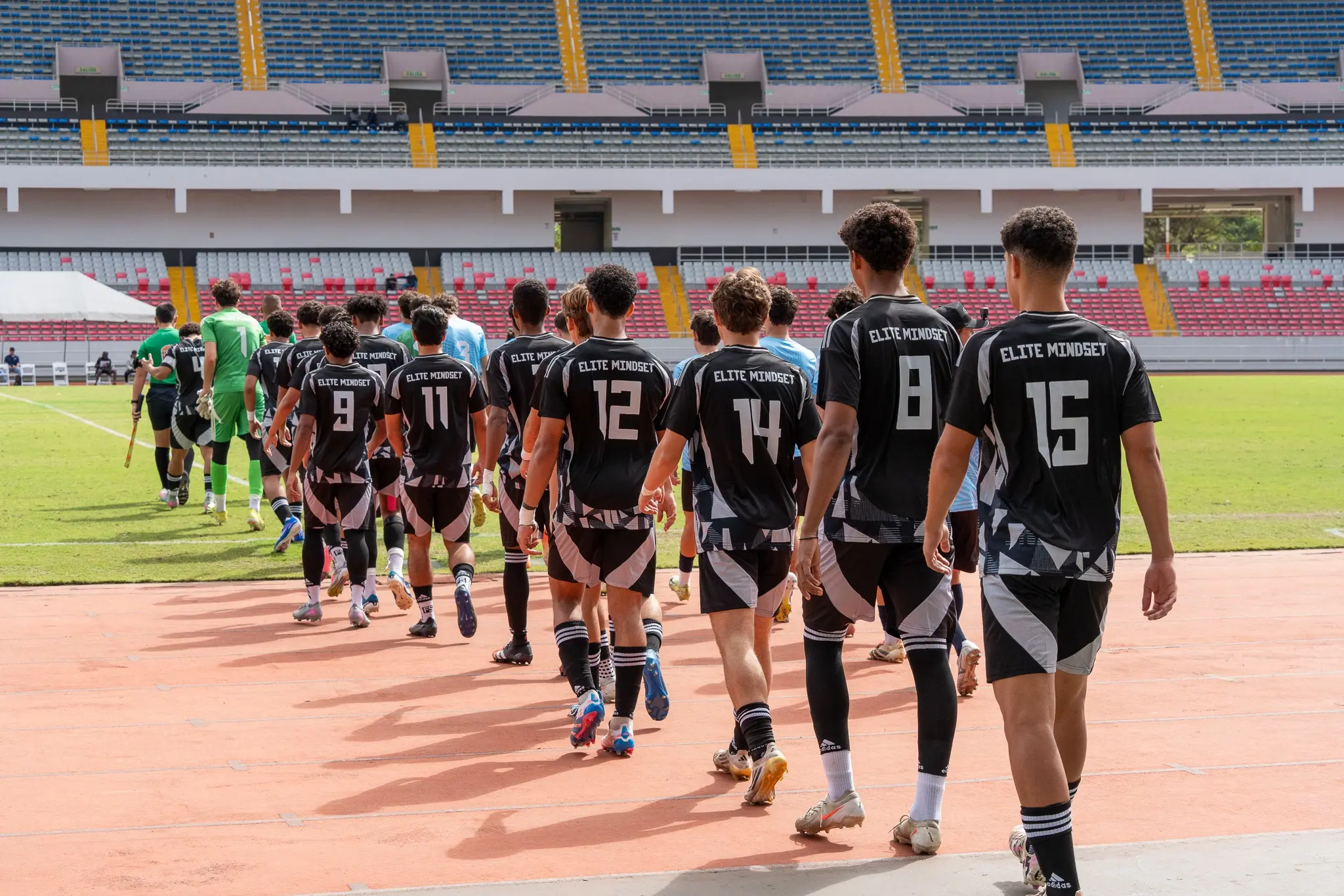 Highlights athletes entering a stadium for a competitive showcase