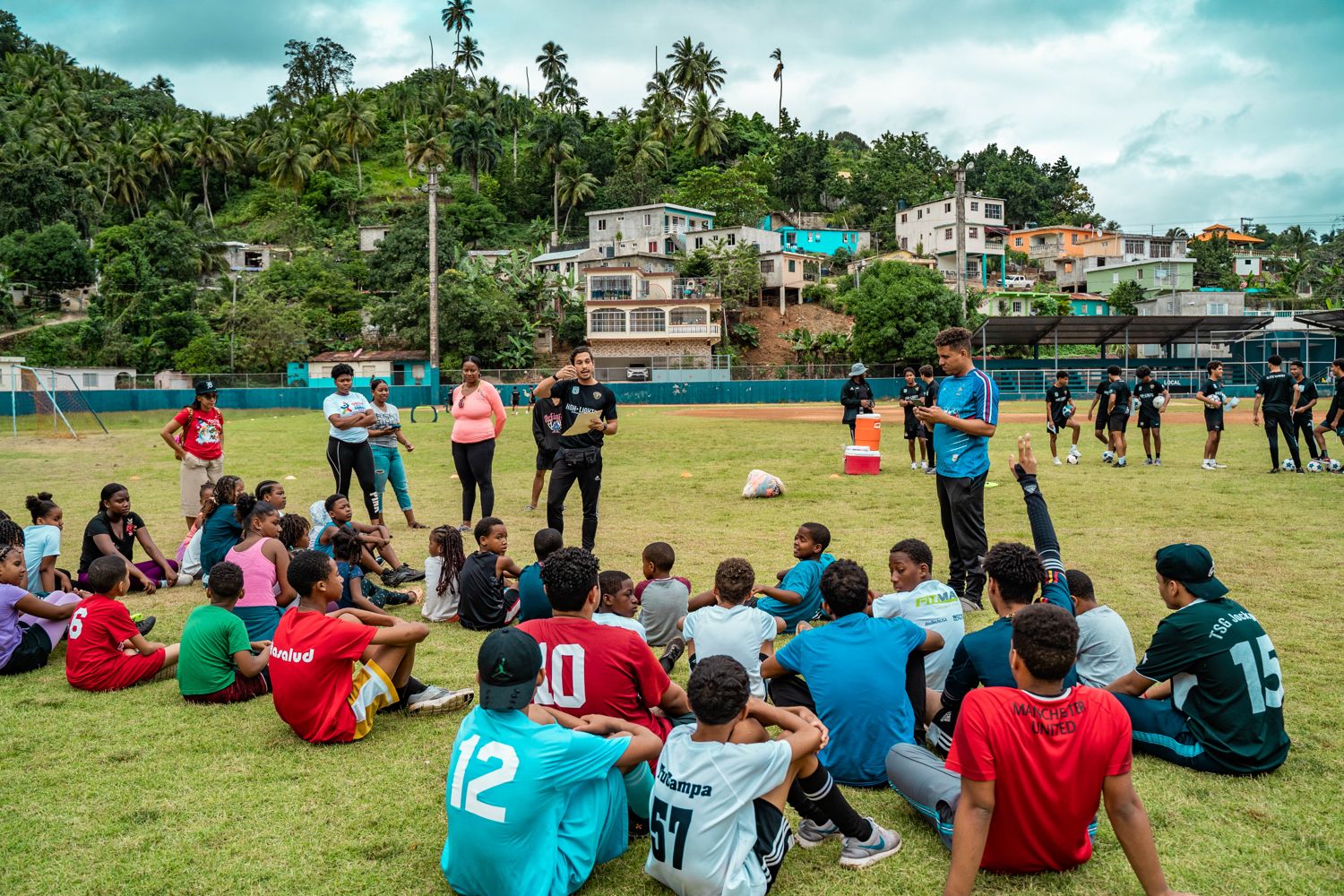 Athletes leading a youth soccer clinic with ASPIRAS