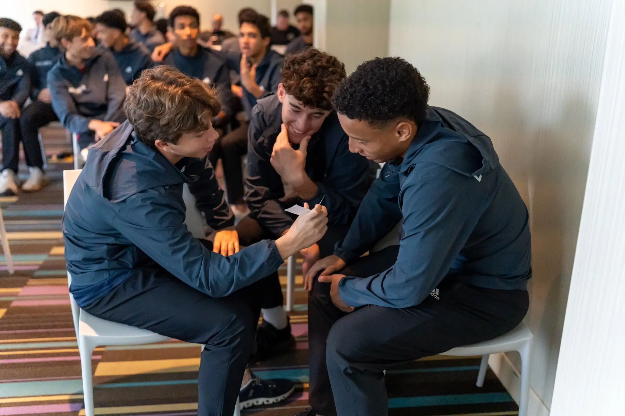 Highlights student-athletes collaborating during a Sport Leadership activity
