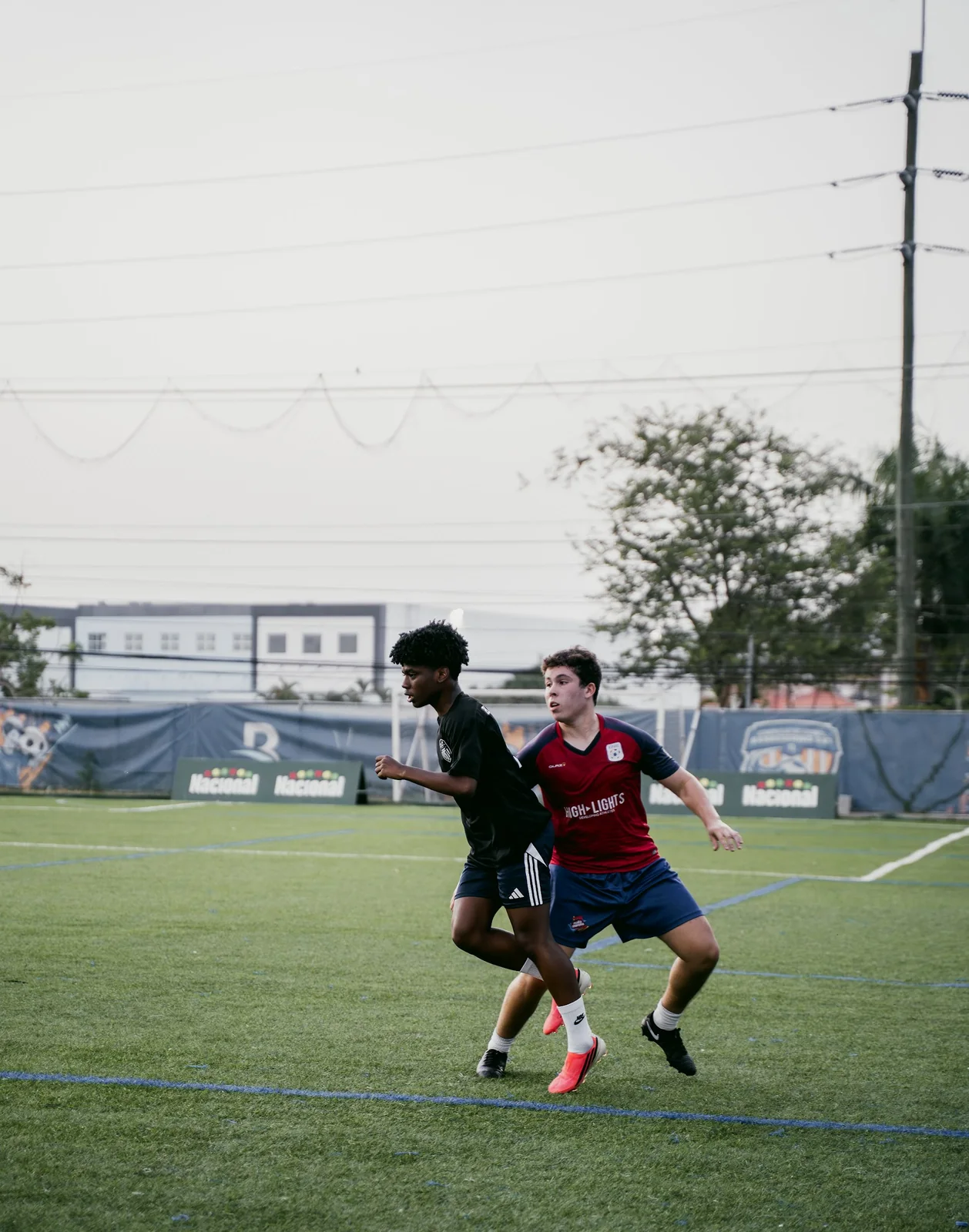 5AM Club athletes competing for possession during a field session